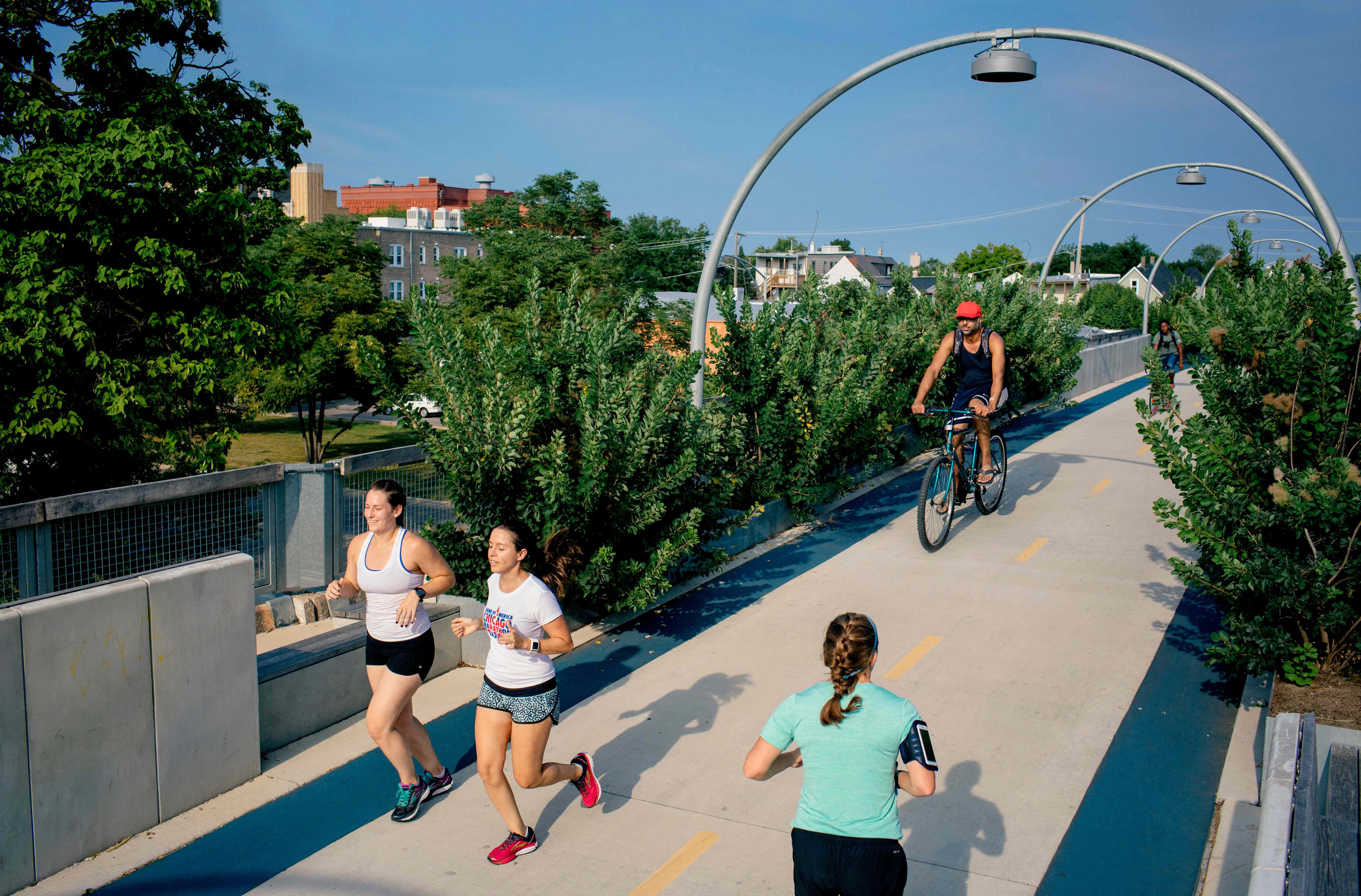 People running and biking on the bike bridge 