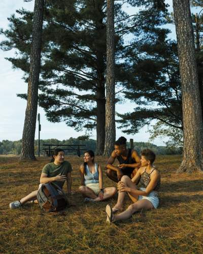 A group sit amongst the trees by Rend Lake