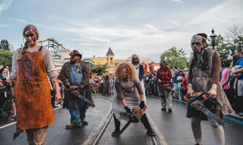 A group of zombies walk through Six Flags