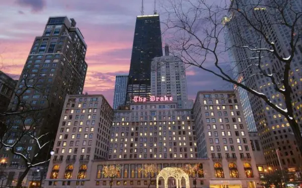 The exterior of The Drake Hotel in the evening with the sun setting