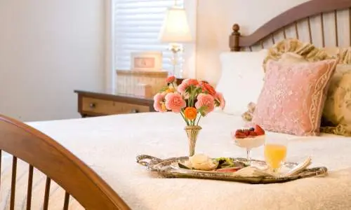 A bed with food on a tray