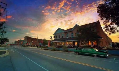 The exterior of a restaurant building at sunset