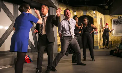 Actors acting on stage at the Chicago Theatre.