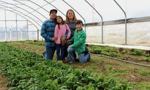 Family in a greenhouse farm.