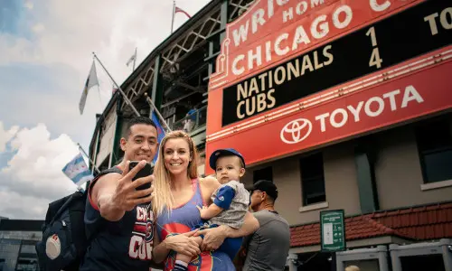 Family posing for a photo outside of a stadium 