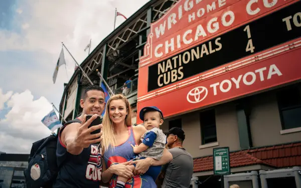 Family posing for a photo outside of a stadium 