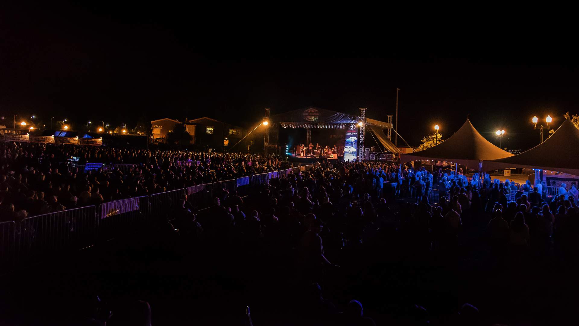 At night, a crowd enjoying a performance at the Peoria Blues and Heritage Festival
