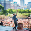 Singer performing for thousands of people at Lollapalooza