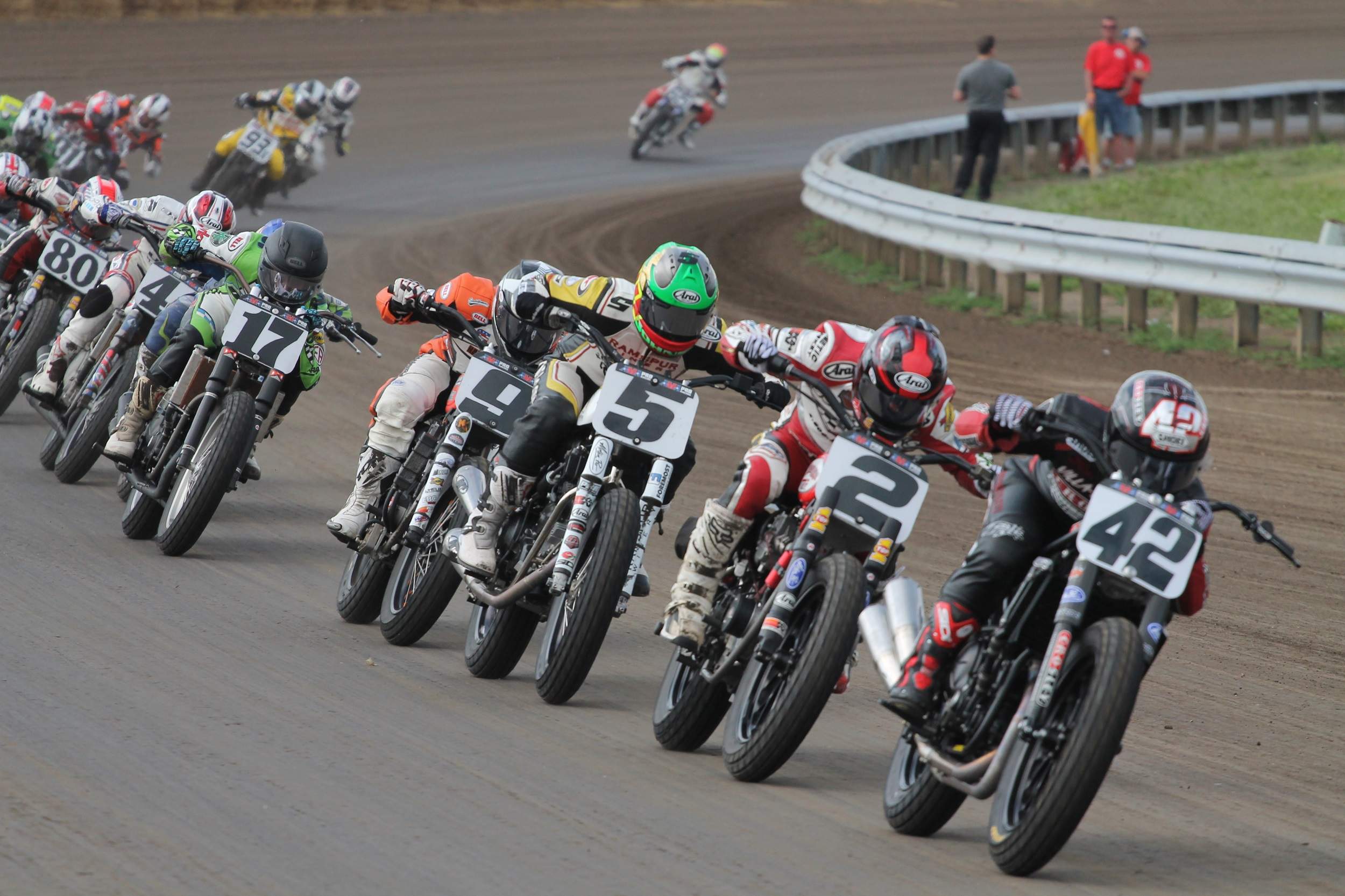 A line of motorcycles racing on the track at the Harley Davidson Springfield Mile