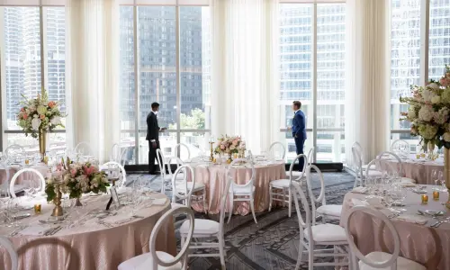 Two men in dinning room styled for a wedding