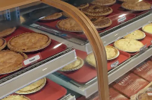 A bakery case full of pies. 