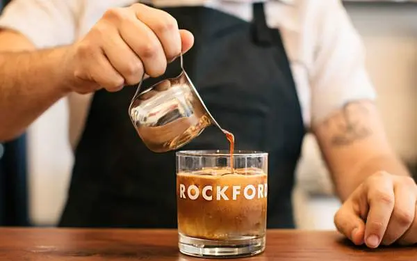 Person pouring coffee
