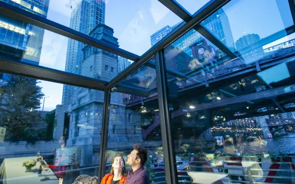 A couple admiring the views from the glass rooftop on the Odyssey Cruise