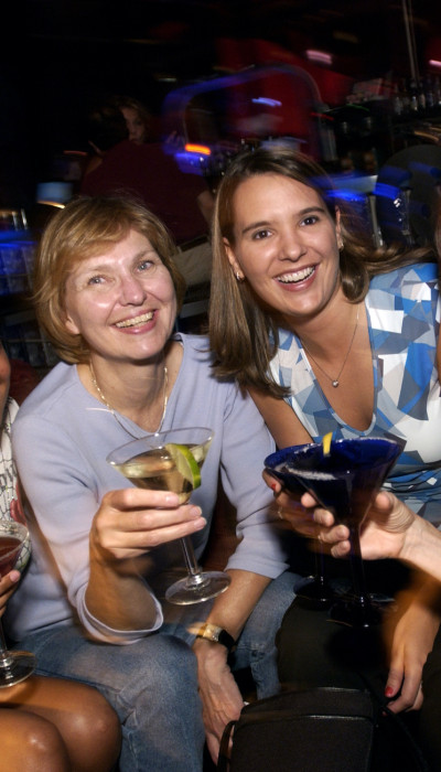 Four women enjoying a night out with cocktails