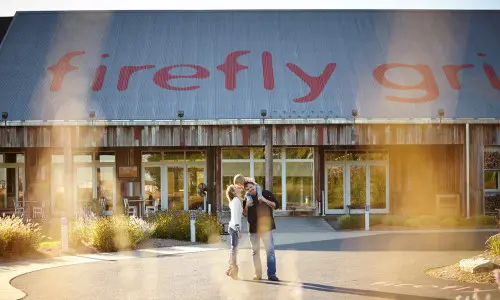 The owners of Firefly Grill stand in front of their establishment
