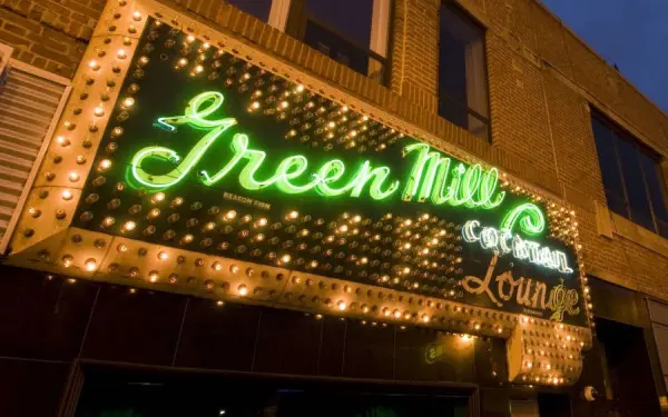 A lit up sign out the front of Green Mill Cocktail Lounge