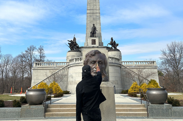 Sherman Dilla Thomas rubs the brass bust of Abraham Lincoln at his tomb in Springfield