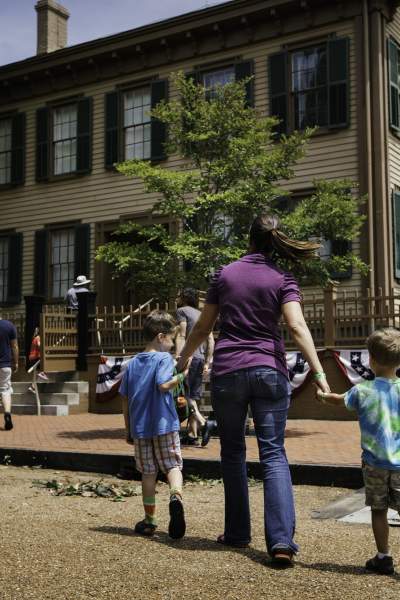 A mother and children walking towards Lincoln's house at the Lincoln Home Historic Site in Springfield