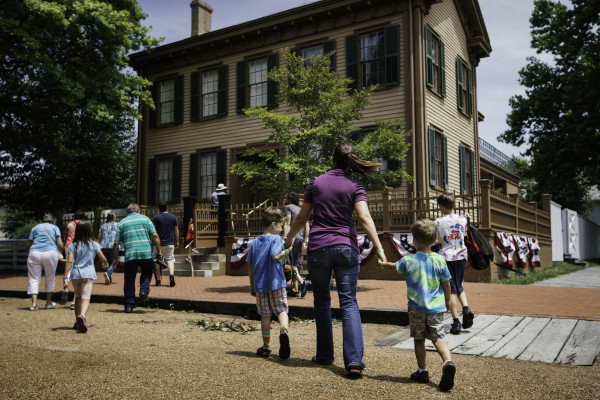 A mother and children walking towards Lincoln's house at the Lincoln Home Historic Site in Springfield
