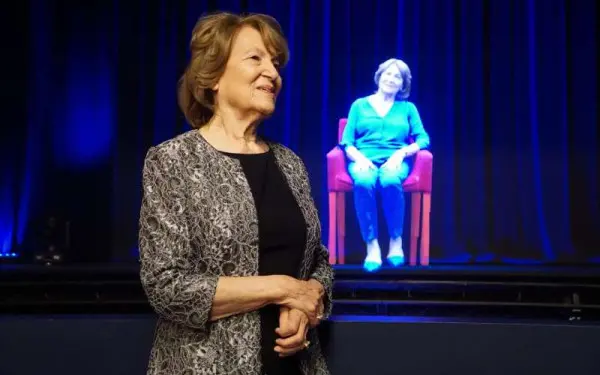 Holocaust Survivor Fritzi Fritzshall standing in front of her hologram