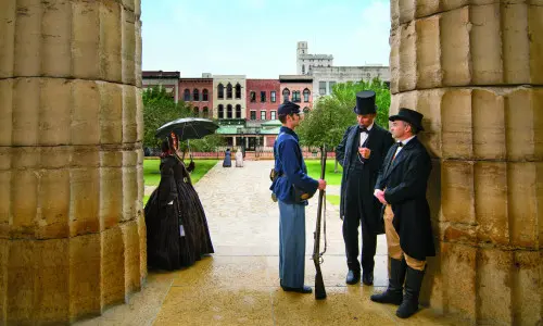 People dressed in older clothing standing around