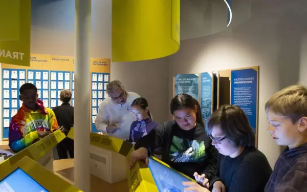 Children and Adults using the interactive screens at the Holocaust Museum