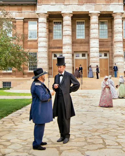 Lincoln in front of large building 
