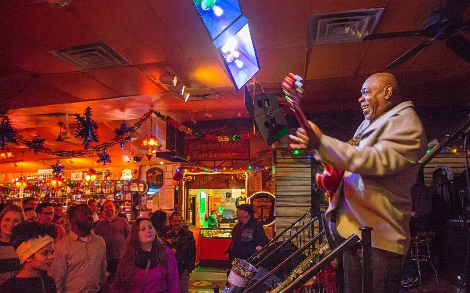 A man playing guitar in a bar