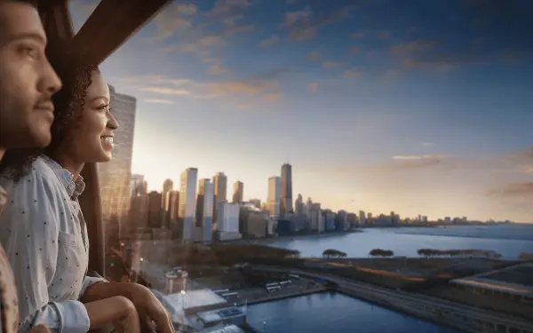 Couple inside the Centennial Wheel during sunset overlooking the city.