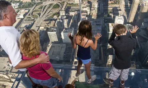 People looking down at building below