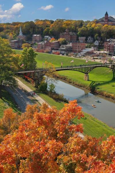 A fall day in Galena, orange foliage and people kayak in a river