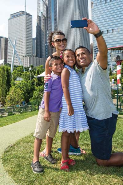 A family snaps a selfie at Maggie Daley Park in Chicago.