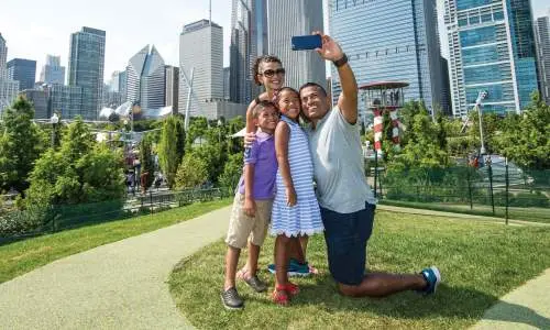 A family snaps a selfie at Maggie Daley Park in Chicago.