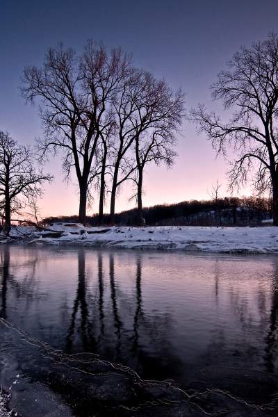 The snow-lined banks of Nippersink Creek at dusk, in Glacial Park, McHenry County