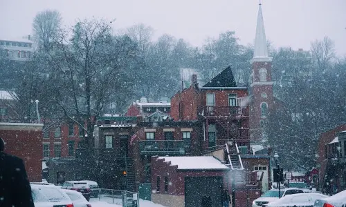 Snow falling on buildings 