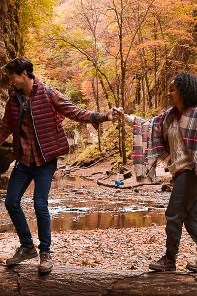Couple hiking through the woods during fall.