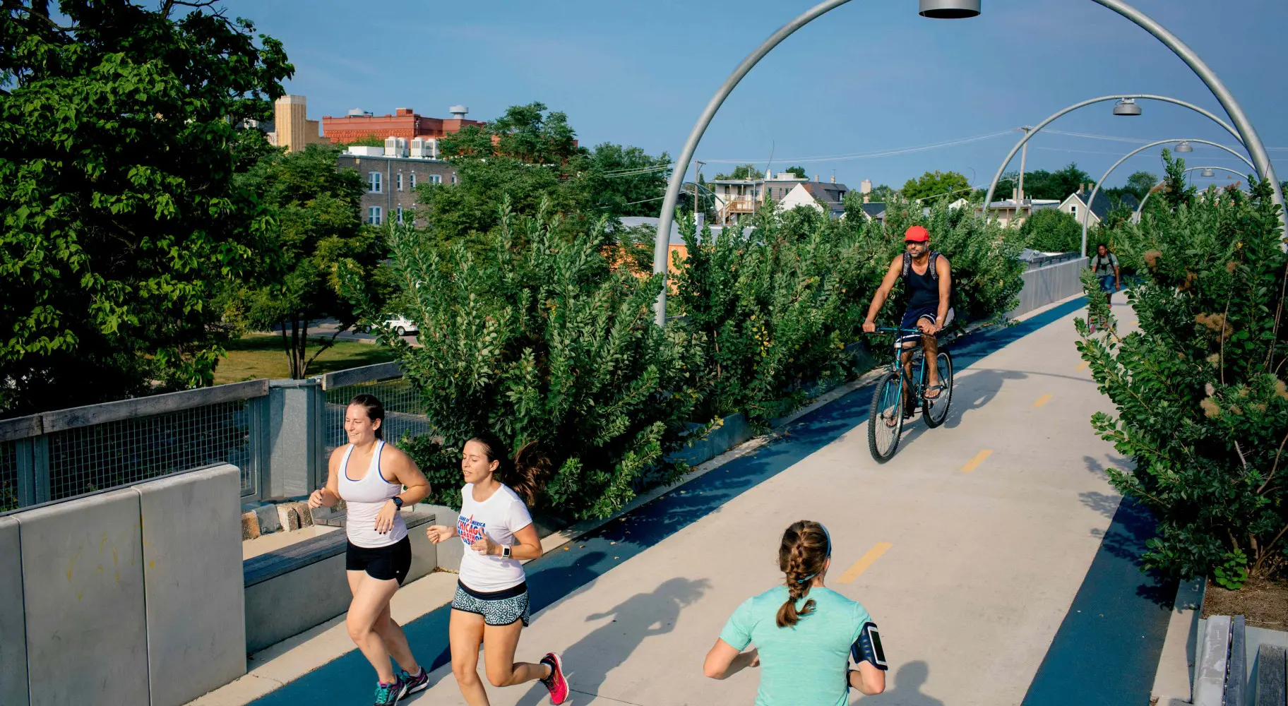 People running and biking on the bike bridge 