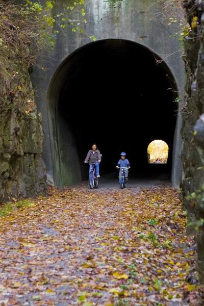 Mother and son biking through a tunnel