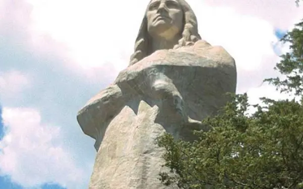 Looking up onto the Black Hawk statue surrounded by trees