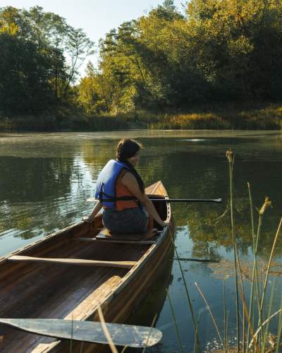 A person on a canoe at Camp Aramoni