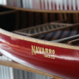 A red canoe with the Navarro Canoe logo.