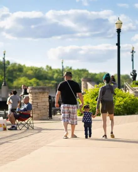 Family outside walking on a sunny day.