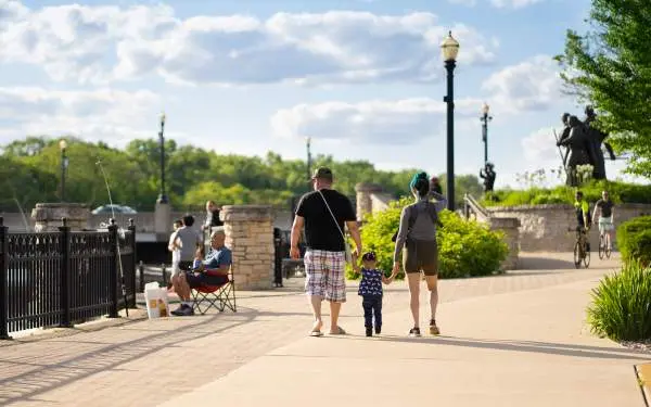 Family outside walking on a sunny day.