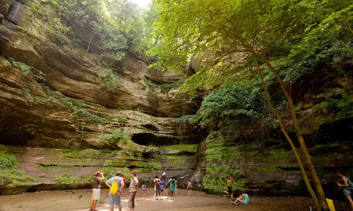 Hikers resting and admiring the waterfall