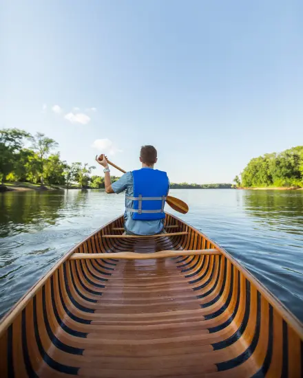 Man Canoeing down river