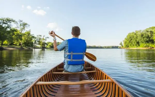 Man Canoeing down river