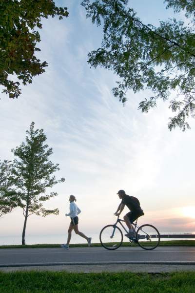 Person running and person biking along the lake front bike path in Chicago