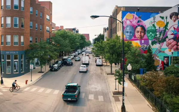 A view of a street with trees and vehicles