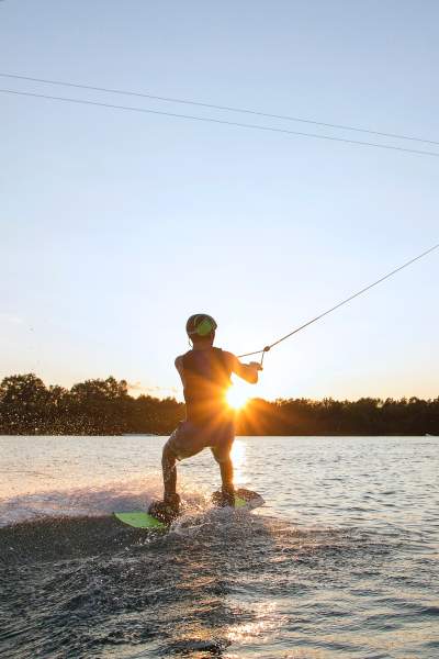 A person wake boarding sunset 
