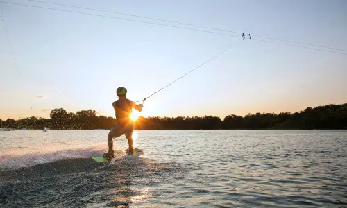 A person wake boarding sunset 